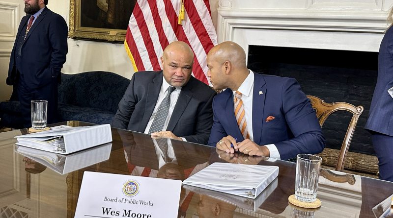 State Treasurer Dereck Davis (left) and Gov. Wes Moore (right) convene after a meeting of the Board of Public Works on Jan. 31, 2024, where each addressed news reports about a sale of the Baltimore Orioles. (Sapna Bansil/Capital News Service)